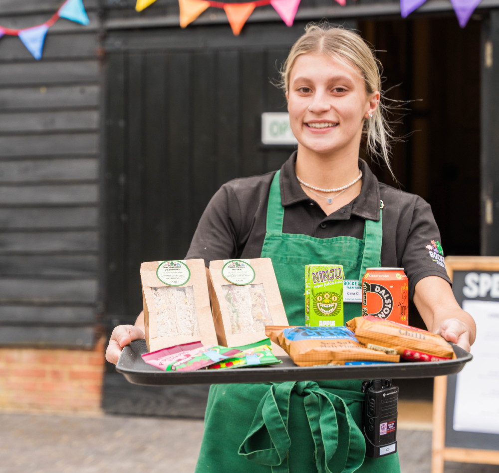 Staff member holding tray of food