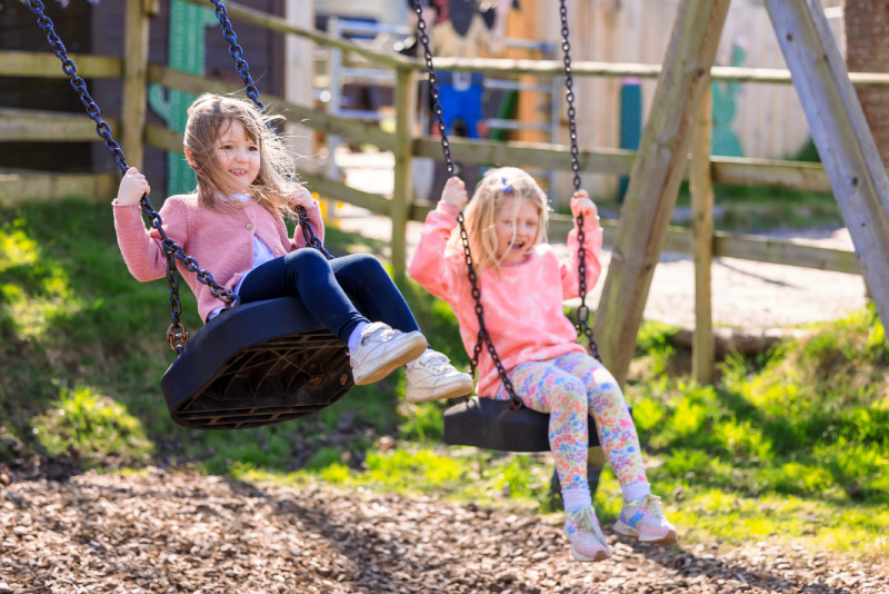 Kids playing on the swings