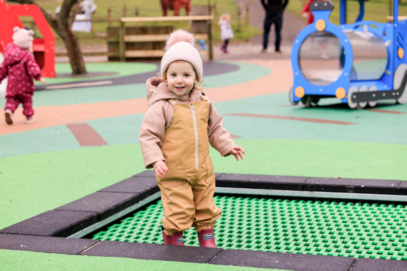 Child playing on the trampolines