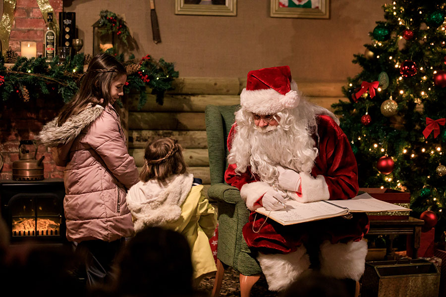 Santa talking to a child in the grotto
